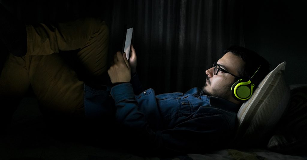 man in bed with phone
