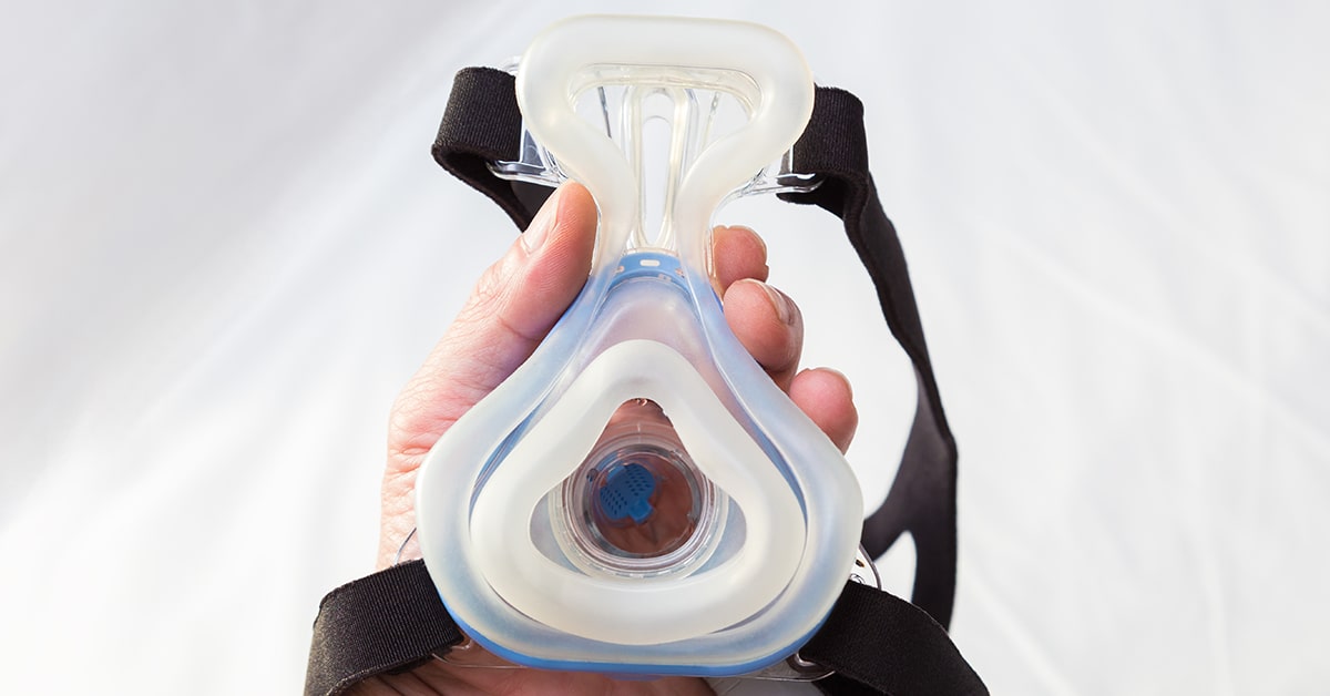 Man holding CPAP mask