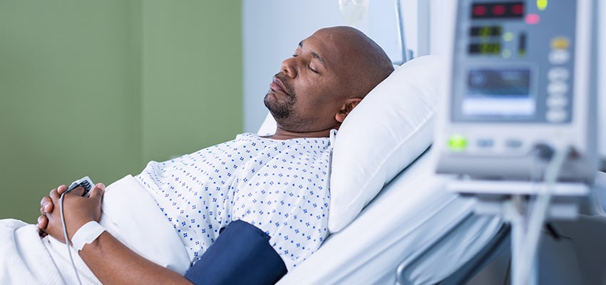 Man sleeping in hospital bed