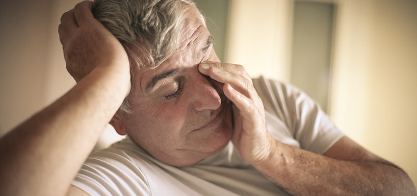Man suffering from side effects from sleep apnea